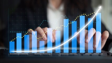 A business professional focuses on analyzing financial data on a laptop, showcasing growth through various charts, including bar graphs and line graphs, indicating success. Copula