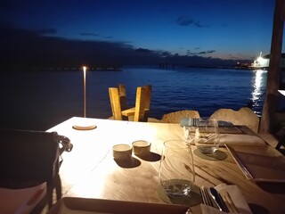 Dinner at night at the shore of the sea on curacao
