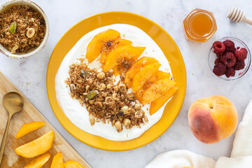 Healthy Breakfast Bowl with Greek Yogurt, Peach Slices, and Homemade Keto Granola
