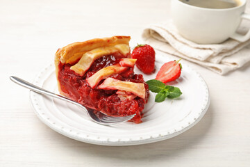 Piece of tasty strawberry pie and berries on white wooden table, closeup