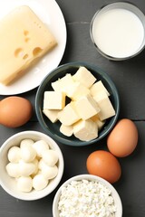Different dairy products and eggs on grey wooden table, flat lay