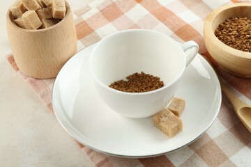 Instant coffee in cup on light table, closeup
