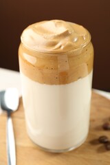 Delicious dalgona coffee in glass on table, closeup