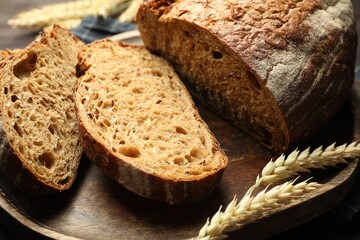 Pieces of fresh bread and spikes on table, closeup