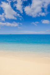 Beautiful tranquil sunny beach with soft sand, calm sea, and clear blue sky peaceful Mediterranean coastline perfect for beauty summer vacation, tourism, nature scenery and travel background wallpaper
