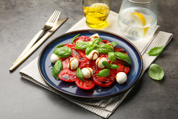 Tasty salad Caprese served with balsamic vinegar on grey table, closeup
