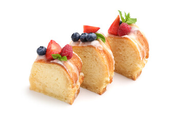 Pieces of delicious bundt cake with berries, glaze and mint isolated on white