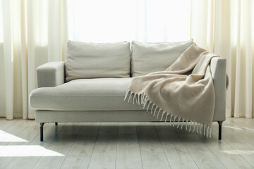 Stylish furniture near window with curtains in living room. Interior design