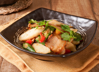 Savory Stir fried Pork with Okra and Yam in broth side view of Asian food