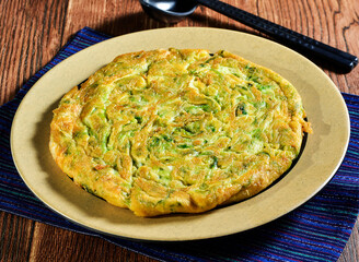 Savory seaweed baked egg omelette in plate close up side view of Asian food