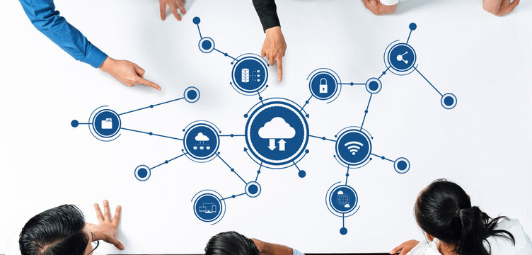 Aerial view of business professionals collaborating on cloud computing concepts. Digital icons on a table illustrate various technology solutions and innovative ideas. Amity