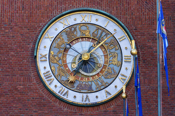 Astronomical clock on Oslo City Hall brick facade