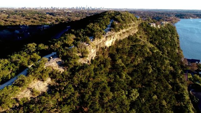 Aerial view of mount bonnell overlooking lake austin on a sunny day
