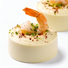 Exquisite shrimp mousse delicacies with delicate garnishes presented beautifully on white background