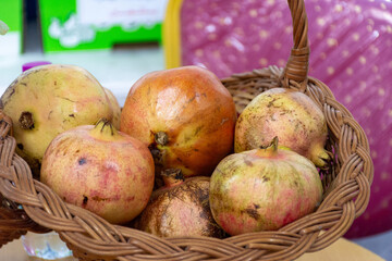 Wicker basket with pomegranate in the market.