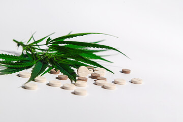 medical cannabis on a light, white background with natural pills