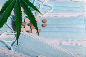 Medical cannabis letter and pills on background with medical, blue masks