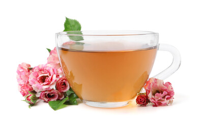 Tasty rose tea in glass cup and flowers isolated on white