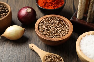 Different aromatic spices on wooden table, closeup