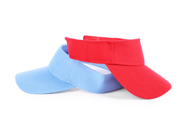 Red and light blue visor caps isolated on white. Mockup for design