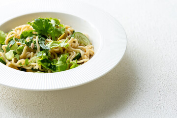 Asian noodle salad in white plate in close-up