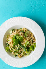 Asian noodle salad in white plate in close-up