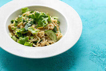 Asian noodle salad in white plate in close-up