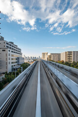 Fototapeta premium View of a modern city skyline from the head of a train in long exposition