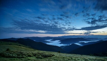 Fototapeta premium a serene night landscape with flowing clouds over distant hills and valleys