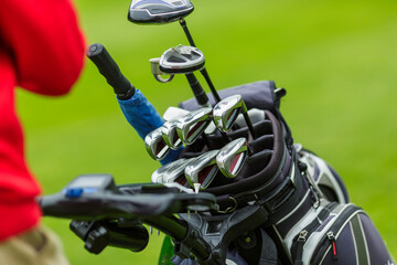 Set of Golf Clubs in Bag on Green Field Closeup Outdoor Sports Equipment for Game Training or...