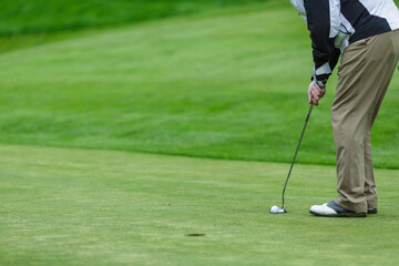 Golf Player Putting Ball on Green Field Closeup Outdoor Sports Action Professional Game or Training