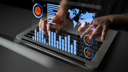 A close-up of hands typing on a laptop, layered with virtual data visualizations, including charts and a world map, representing modern data analysis in a business setting. Impute