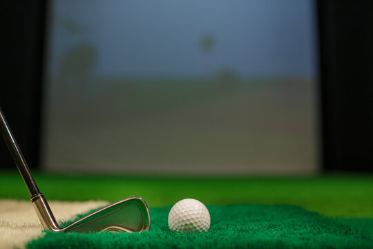 Golf Ball and Iron Club on Artificial Turf in Indoor Golf Simulator for Training or Practice