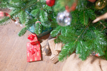 Firewood and Colorful Gifts Beneath Tree