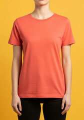 A woman models a plain orange t-shirt in a simple studio shot, perfect for showcasing casual and athletic apparel against a vibrant yellow background.