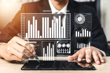 A business professional is focusing on data analytics and market planning while using a digital tablet in a modern office. The image showcases various data visuals. Impute