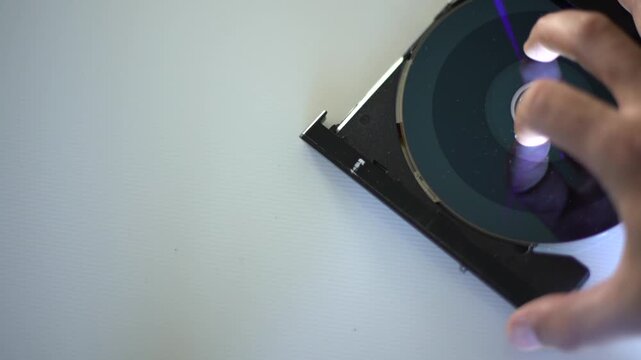 hand holding a compact disc