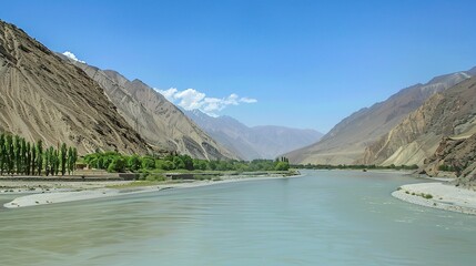 Scenic view of the Indus River, a historic waterway flowing through Pakistan and India, featuring calm waters, fertile riverbanks, traditional boats, rural villages, and lush vegetation