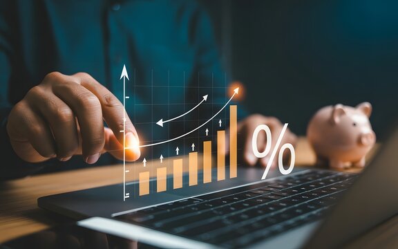 Financial Growth Illustration: A visual representation of financial success, with hands interacting with a laptop displaying a growing graph and a percentage symbol next to a piggy bank.
