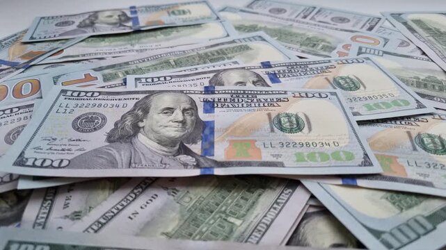 Stack hundred dollar bills. Pile US dollars with number 100 on them. Concept of wealth and abundance