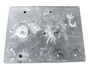 Close up of a textured climbing wall surface with colorful holds and chalk dust, representing extreme sports and fitness