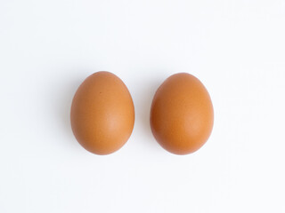 Two brown chicken eggs isolated on a white background. Concepts for food, ingredient, protein, healthy, breakfast, organic, cooking, fresh, isolated, pair.

