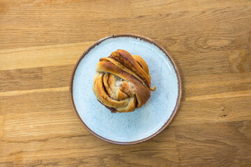Above view of sweet and buttery, Kanelsnurrer  a baked Norwegian cinnamon bun dessert that is twisted and tied into knots, spiced and lined with sugar cardamom and cinnamon