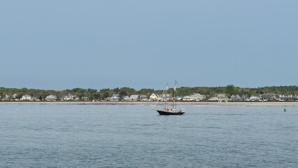 A sailboat off the coast of Maine in the summer