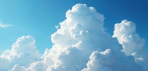 Vast blue sky with dramatic fluffy cumulus clouds. Close-up view of bright white cloud formations against clear sky background. Natural weather phenomenon, summer atmosphere, good for design