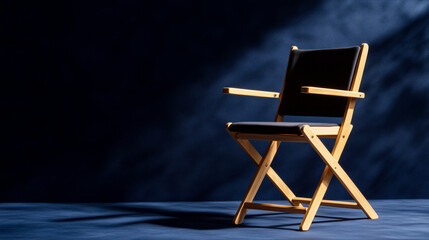 Obraz premium Vintage film set style directors chair empty against an indigo textured wall