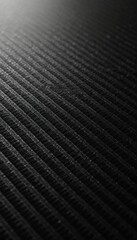 Abstract black carbon fiber texture with subtle gradient finish. Detailed illustration repeating pattern of fine lines, metallic sheen, evoking modern industrial design. Material surface offers