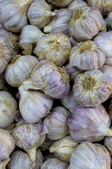 Lots of blackberries. Garlic in a box. Sale of garlic at the market and store. Background. Top view. Conservation for the winter. Farm products. Vegetarianism.