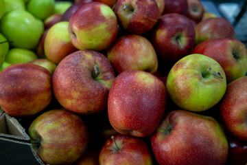 Many ripe red, green apples. Sale of apples at the market and store. Background. Top view. Concept sale at the market and store. Farm products.