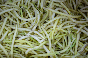 Asparagus bean pods. Asparagus beans in a box. Sale of asparagus beans at the market and store. Background. Top view. Concentration of canning for the winter. Farm products. Vegetarianism.